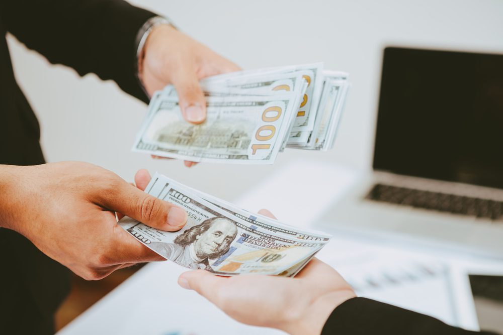 Lender handing over estate loan cash to woman