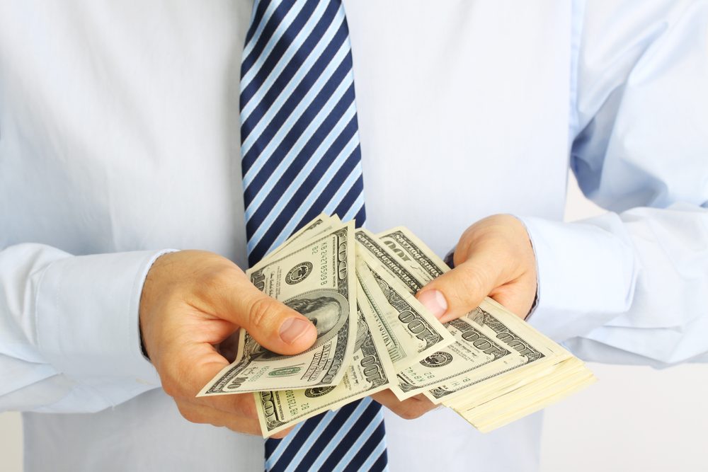 Man holding Probate Loan money