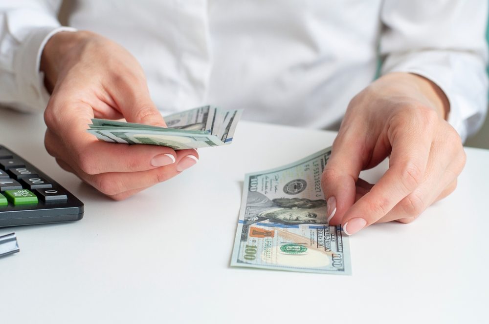Man counting Inheritance Advance money on white desk